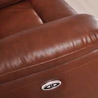 Close-up of a brown leather recliner with a visible brand logo.