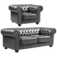 Grey leather Chesterfield sofa and armchair on a white background