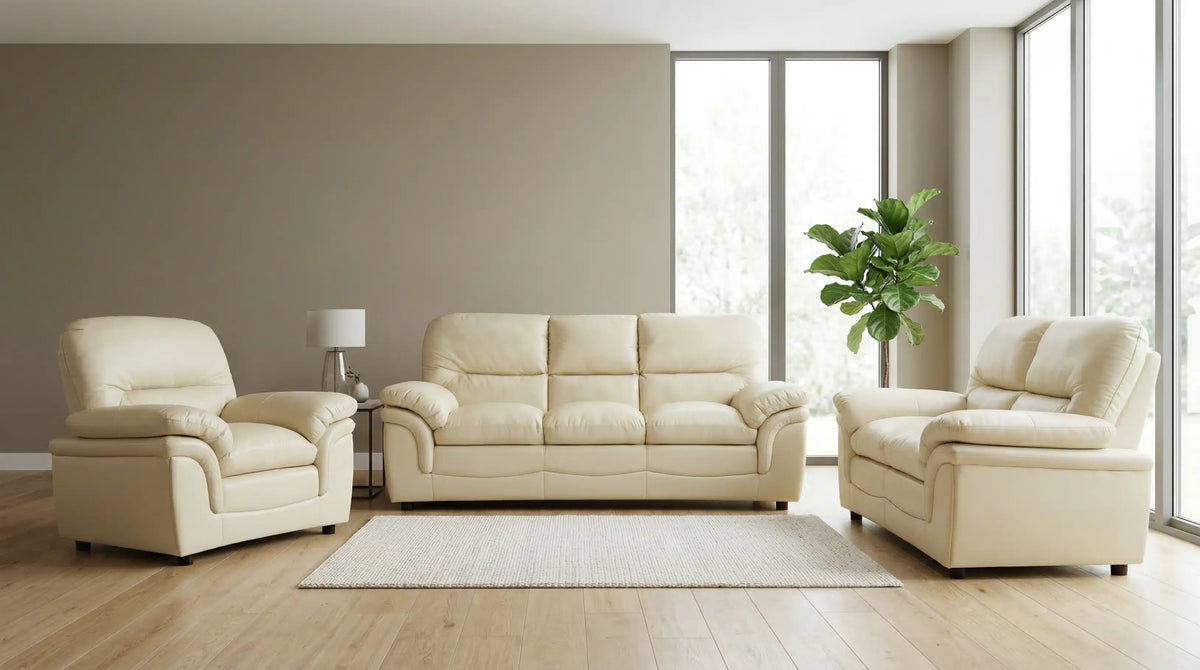 Beige leather sofa set in a modern living room with large windows.