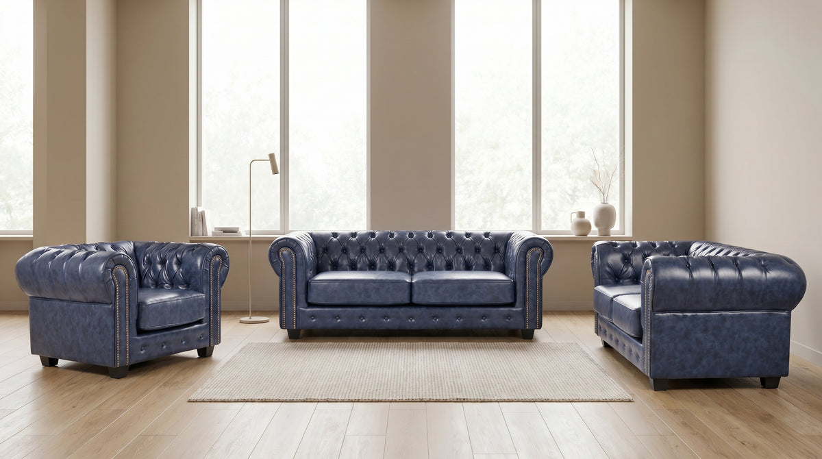 Blue Chesterfield leather sofa set styled in a living room