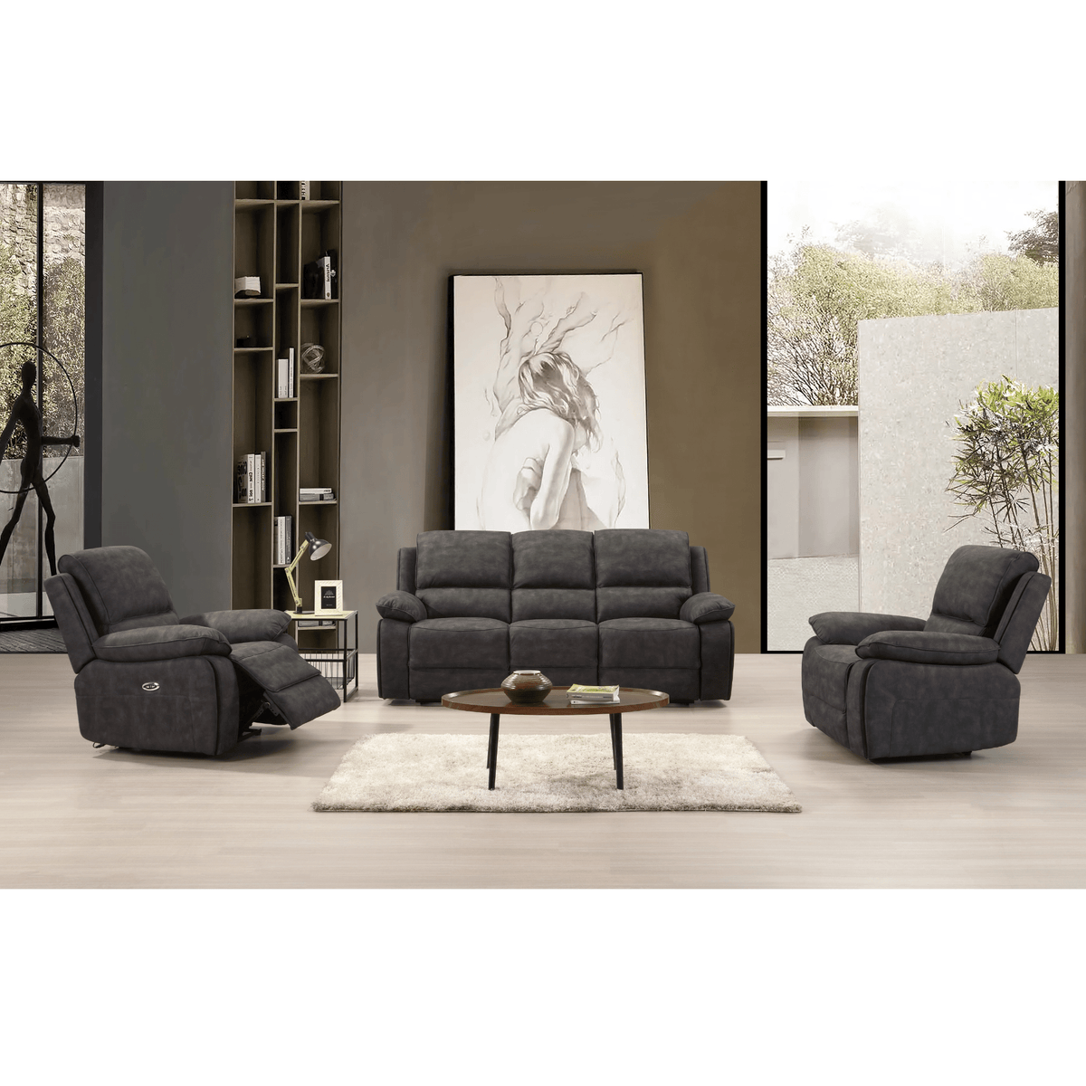 Grey sofa set in a modern living room with a bookshelf and artwork.