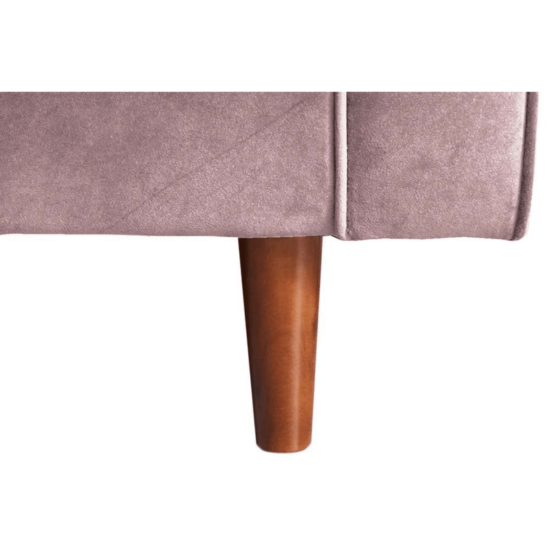 Close-up of a pink upholstered chair with a wooden leg on a white background