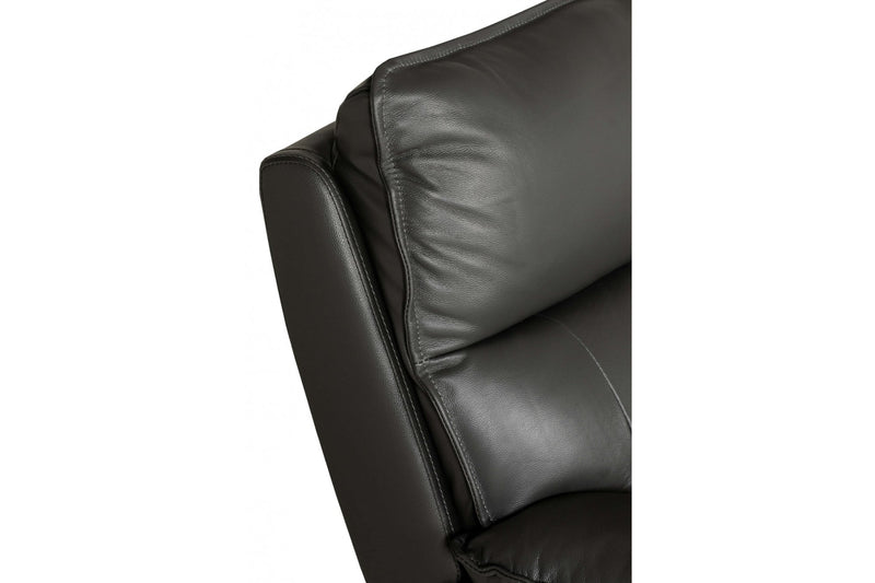 Close-up of a dark gray leather sofa corner on a white background